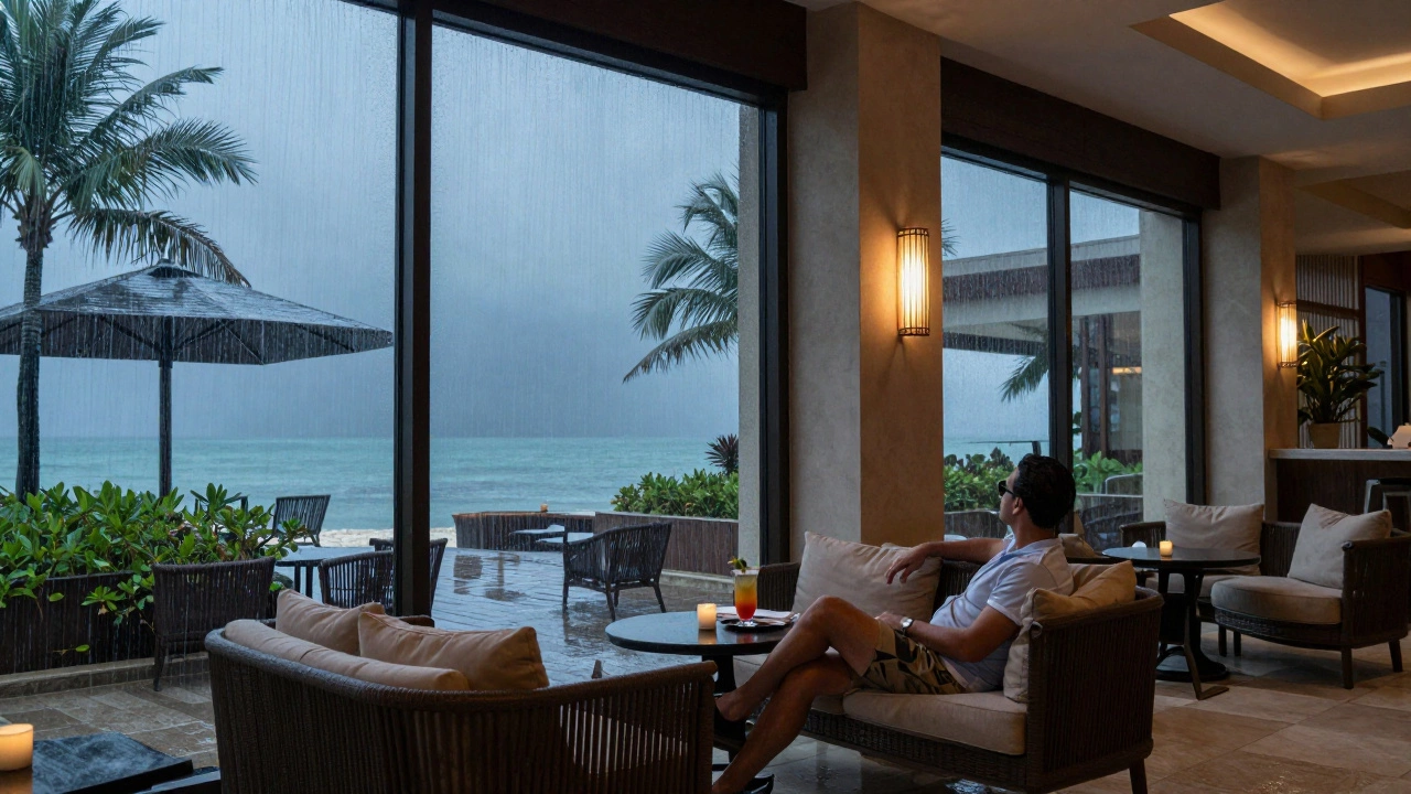 Traveler enjoying a drink indoors while rain falls outside a Mexican resort.
